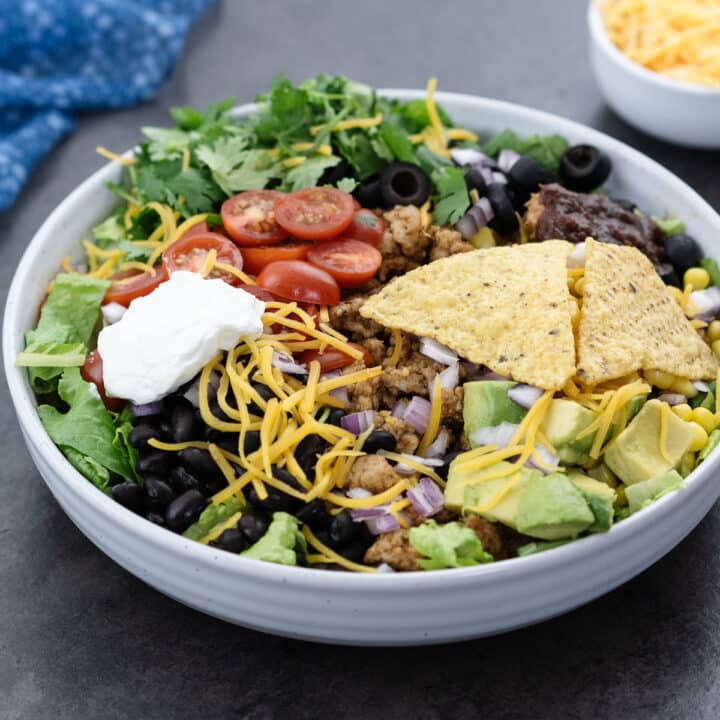 Taco salad served in a white bowl.