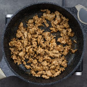 A pan with seasoned ground chicken.