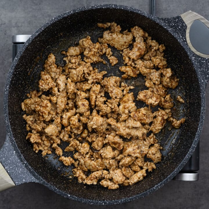 A pan with seasoned ground chicken.