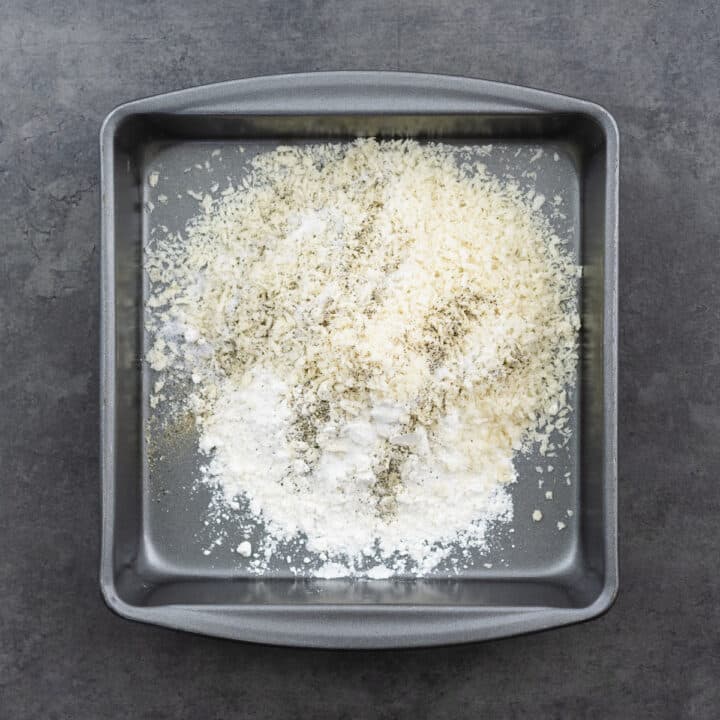 A shallow tray with flour and breadcrumbs seasoned with basic seasonings.