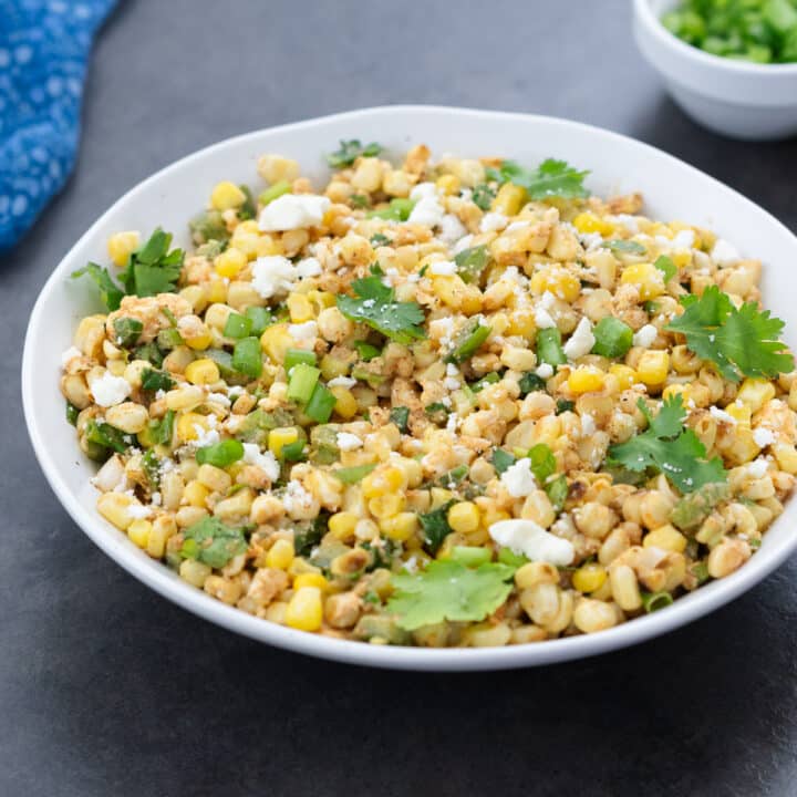 Mexican Street Corn Salad served in a white bowl, beautifully presented and ready to enjoy.