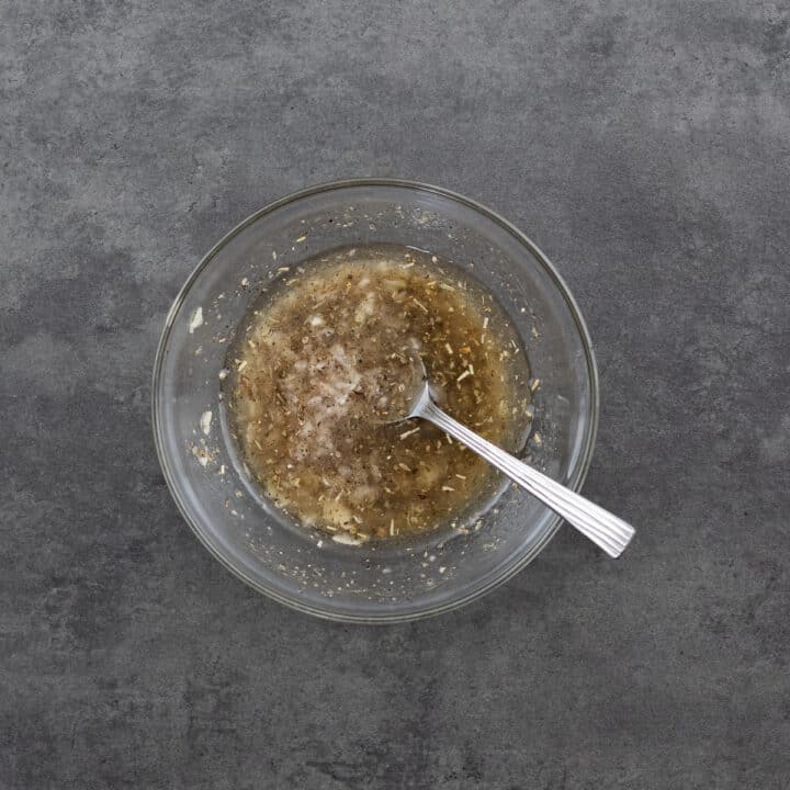 A bowl with dressing for couscous salad.