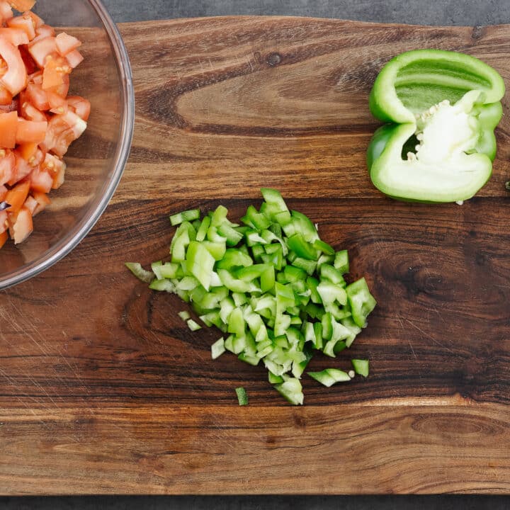 Chopped bell peppers on a wooden board.