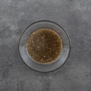 A bowl filled with salad dressing, ready to be used.