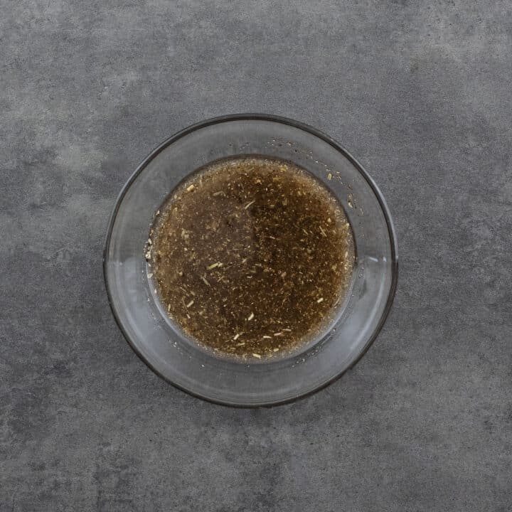 A bowl filled with salad dressing, ready to be used.