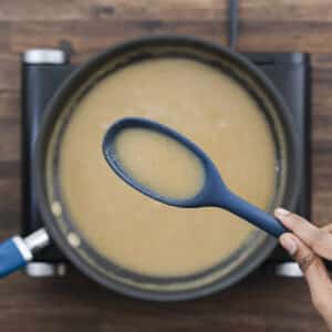 A close-up showing the thick, smooth consistency of the gravy mixture.