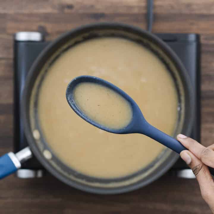 A close-up showing the thick, smooth consistency of the gravy mixture.