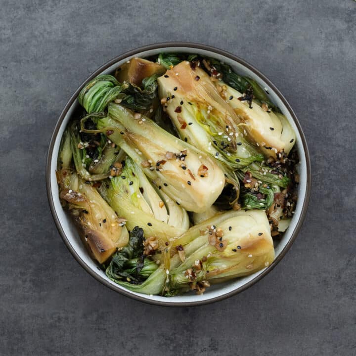 Sautéed bok choy served in a sleek black bowl, ready to be enjoyed.