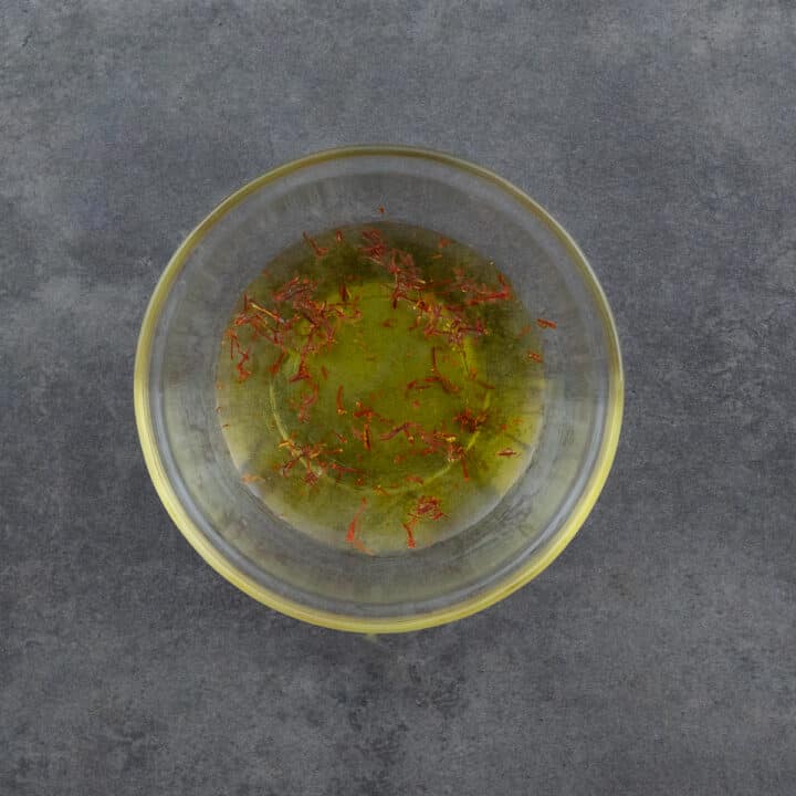 Saffron strands blooming in a bowl of water.