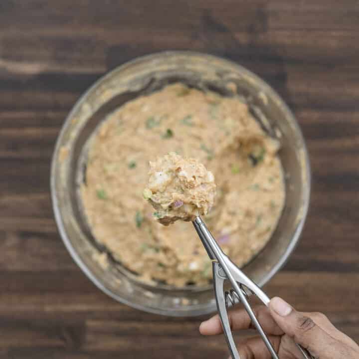 Ground chicken mixture scooped with a cookie dough scooper.