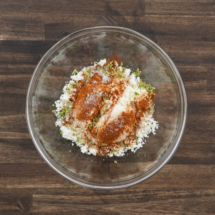 A bowl filled with Cotija cheese seasoned with paprika, garlic powder, salt, and lime zest.