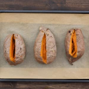Baked sweet potatoes with a slit opened in the middle.