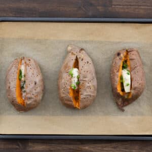 Baked sweet potatoes seasoned with herbs and spices.