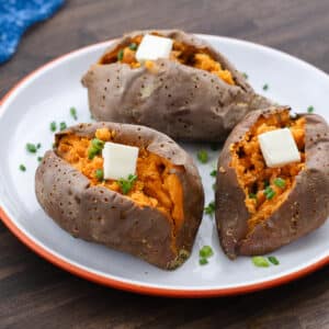 Baked sweet potatoes served in a white plate.