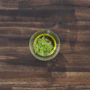 Bowl of olive oil mixed with fresh lime zest.