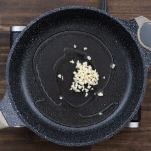 Pan with minced garlic sautéing in olive oil.