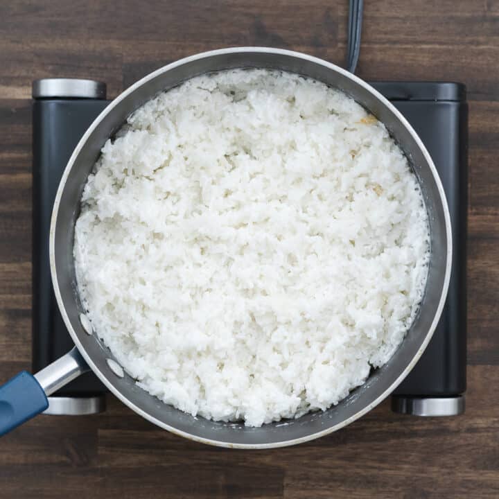 A pan showcasing beautifully fluffed coconut rice after cooking.