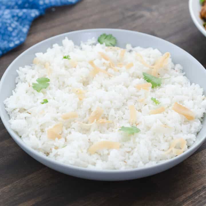 Coconut rice served in a white bowl, garnished and ready to enjoy.