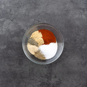 A bowl with spice powders for making dry rub for ribs.