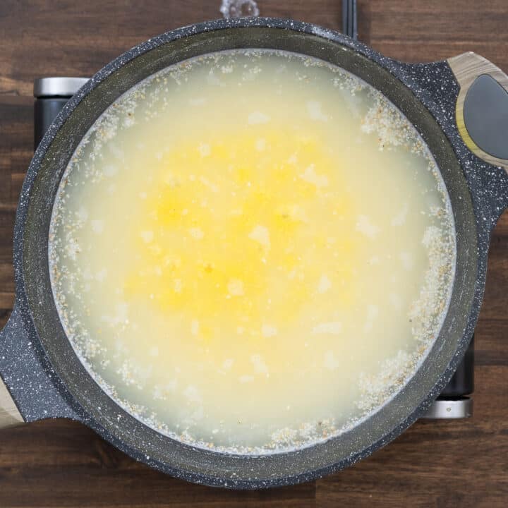 A pan with polenta cooking in water.