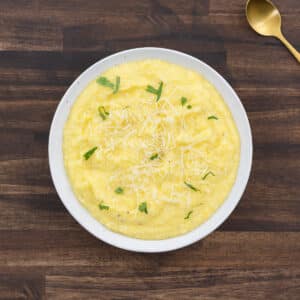 Creamy polenta served in a white bowl.