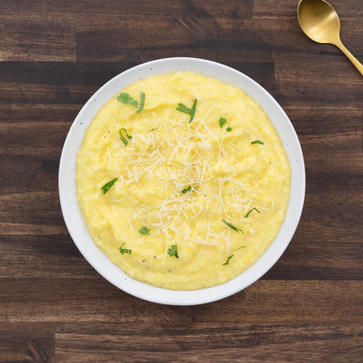 Creamy polenta served in a white bowl.