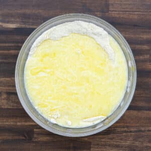 The wet ingredients combined with the dry ingredients, creating a smooth, well-mixed batter for the cornbread.
