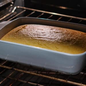 The cornbread is baking in the oven, gradually turning golden.