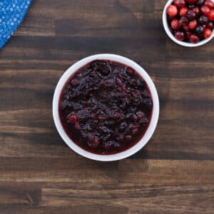 Freshly made cranberry sauce served in a white bowl, ready to enjoy.