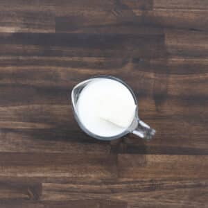 A measuring cup with butter and milk.