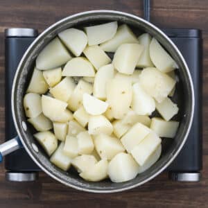 A pot with potatoes being heated to evaporate residual water.