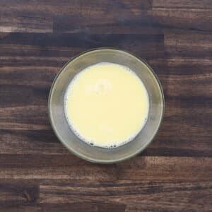 A bowl with the beaten egg mixture.
