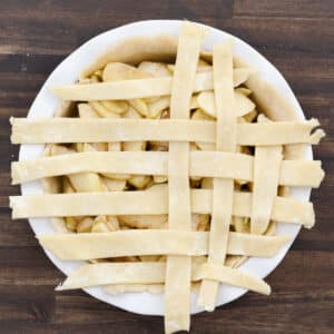 Half of the lattice pattern completed over the apple pie filling.
