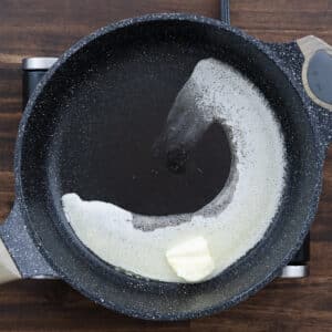 A pan with butter melting over medium heat.