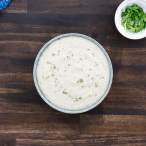A bowl of creamy, rich homemade Cream of Chicken soup, ready to be served.