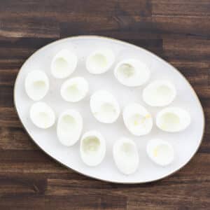 A white serving tray with empty egg whites, ready to be filled.