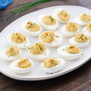 Deviled eggs served on a white serving tray, ready to enjoy.