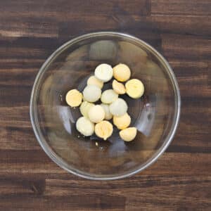 A mixing bowl filled with egg yolks, ready to be mashed.