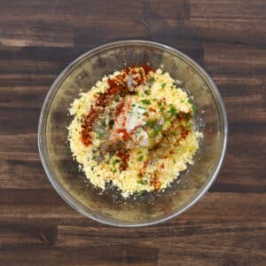 A bowl of smooth egg yolk mixture seasoned with herbs and seasonings.