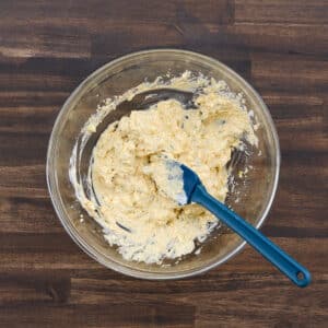 A bowl with well-mixed egg yolk filling, stirred with a spatula.