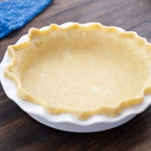 A pie dish with pie crust, ready for baking.