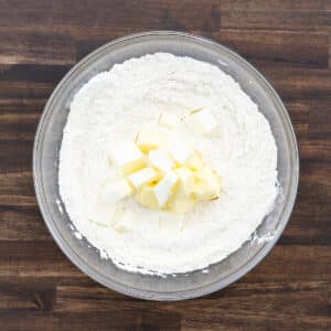 A bowl containing flour and cold fats like butter and shortening.