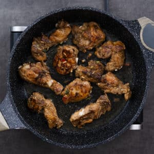 A pan with perfectly seared chicken, showcasing a golden-brown crust.
