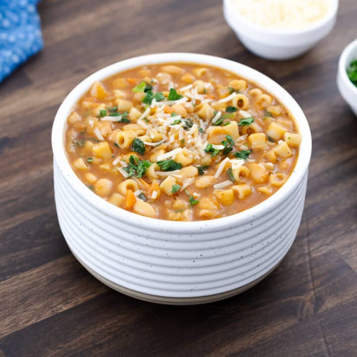 A warm bowl of pasta e fagioli soup, served in a white bowl, ready to enjoy.