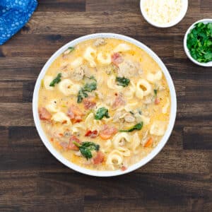 Tortellini soup served in a white bowl, ready to enjoy.
