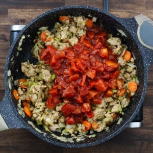 Pan with meat, sautéed veggies, roux, and diced tomatoes.