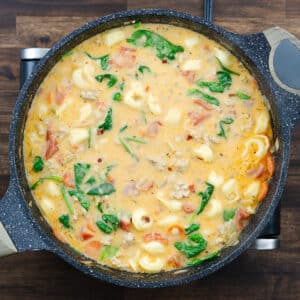 Pan with creamy tortellini soup, ready to serve.