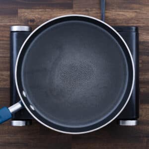 A pot of water starting to boil, preparing for pasta cooking.
