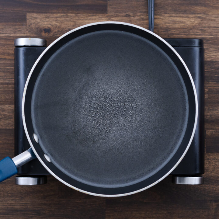 A pot of water starting to boil, preparing for pasta cooking.