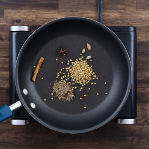 Pan with dry spices ready for toasting.